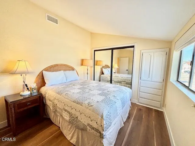 a bedroom with a bed and a mirror