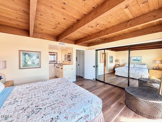 3949 Ocean Drive Oxnard, CA 93035 - Photo 9 of 24 a bedroom with a large bed and wooden floor