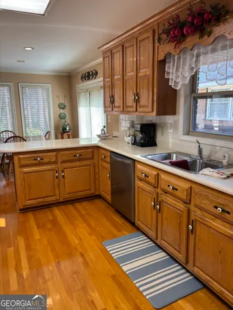 a large kitchen with stainless steel appliances granite countertop a sink and cabinets