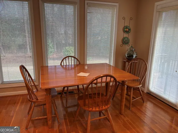 a view of a dining room with furniture and wooden floor