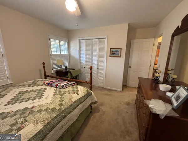 a bedroom with a bed and flat screen tv