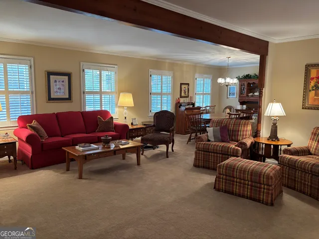 a view of a dining room with furniture and chandelier