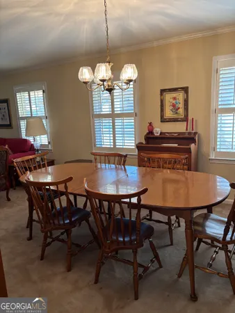 a view of a dining room with furniture and chandelier
