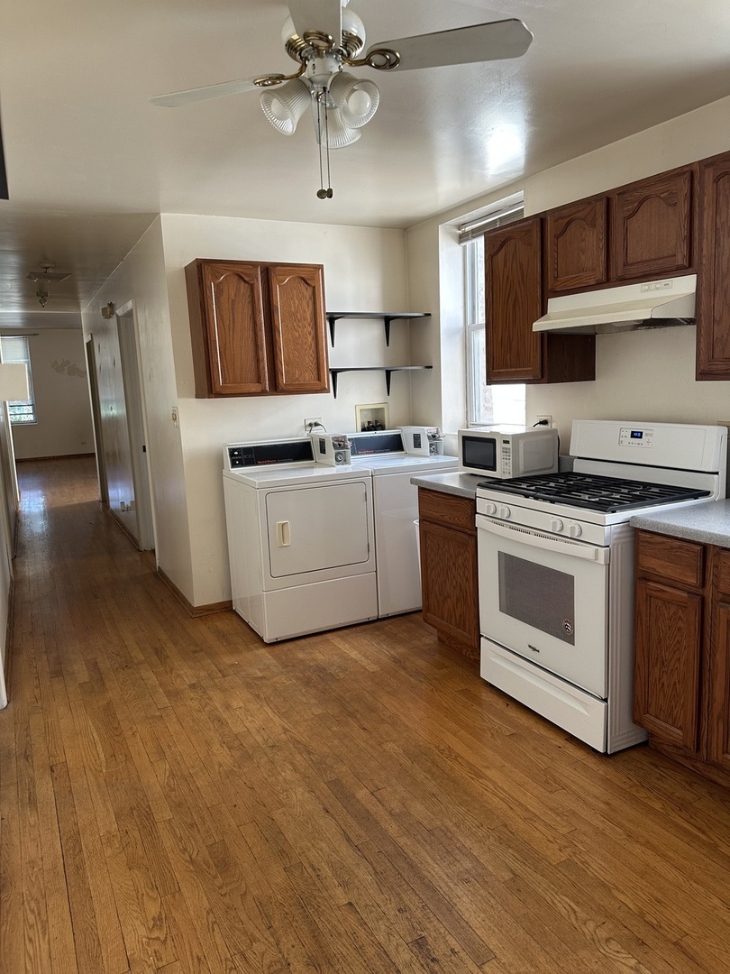 847 South Miller Street Chicago, IL 60607 - Photo 5 of 8 a kitchen with stainless steel appliances granite countertop a stove sink and cabinets