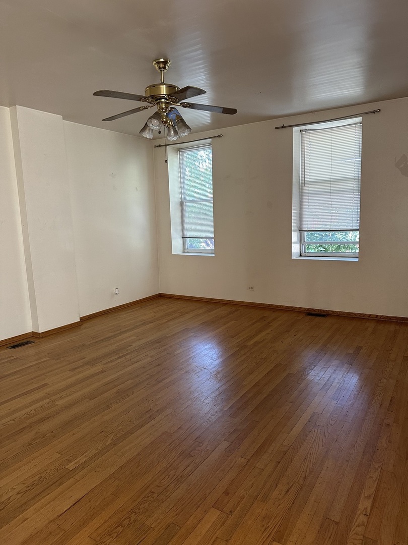 847 South Miller Street Chicago, IL 60607 - Photo 6 of 8 a view of an empty room with wooden floor and a window