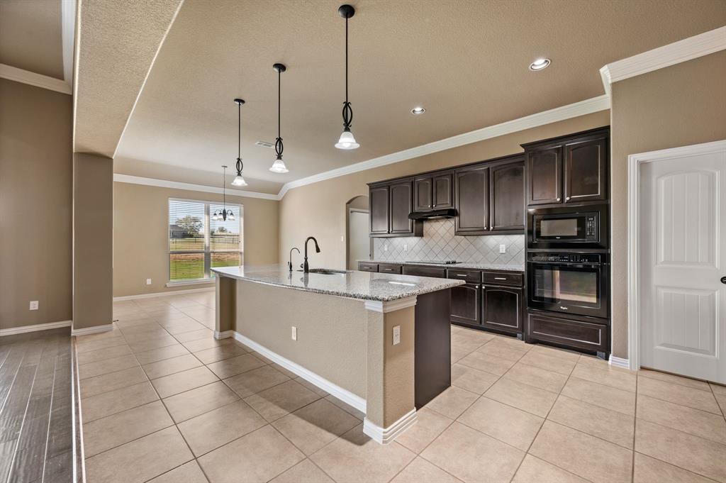 282 Heather Lane Decatur, TX 76234 - Photo 11 of 36 a large kitchen with stainless steel appliances granite countertop a stove and cabinets