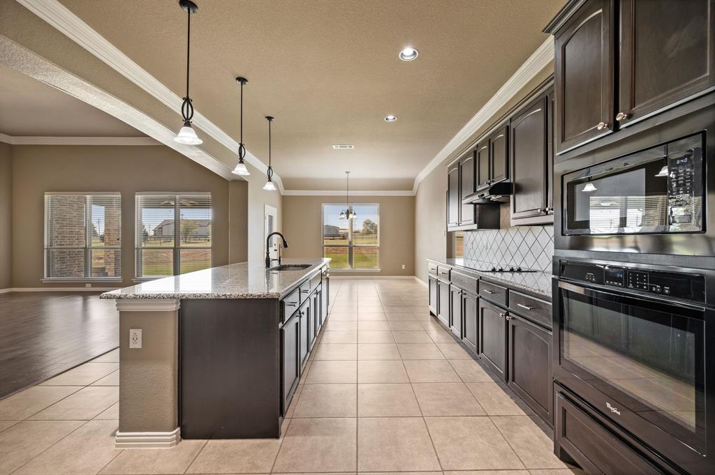 282 Heather Lane Decatur, TX 76234 - Photo 12 of 36 a large kitchen with stainless steel appliances granite countertop a stove and a sink