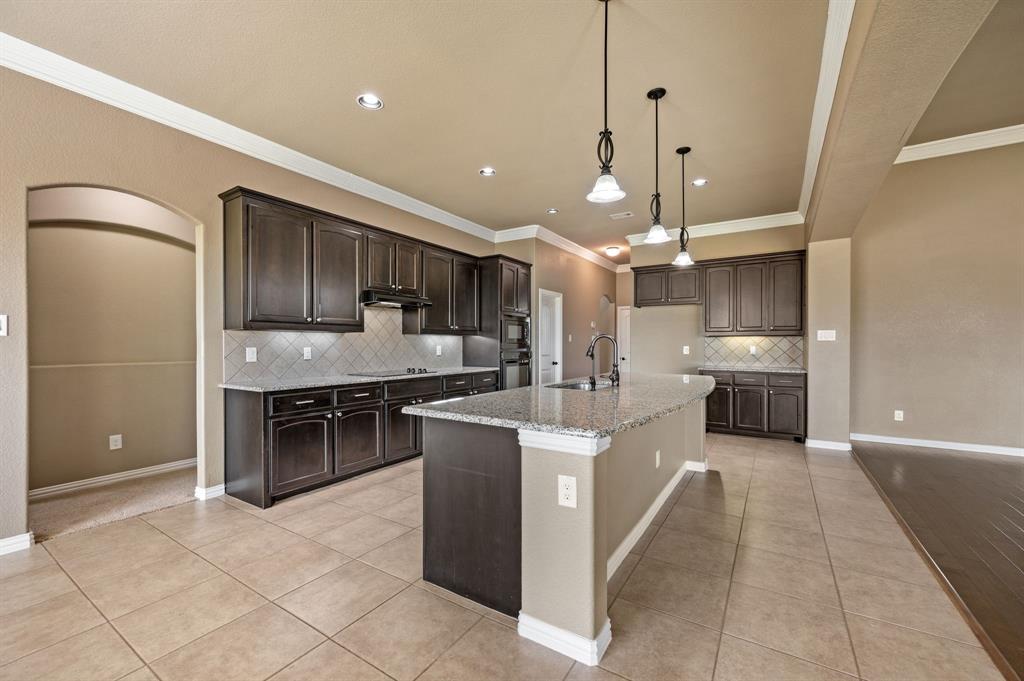 282 Heather Lane Decatur, TX 76234 - Photo 13 of 36 a large kitchen with stainless steel appliances kitchen island granite countertop a sink and cabinets