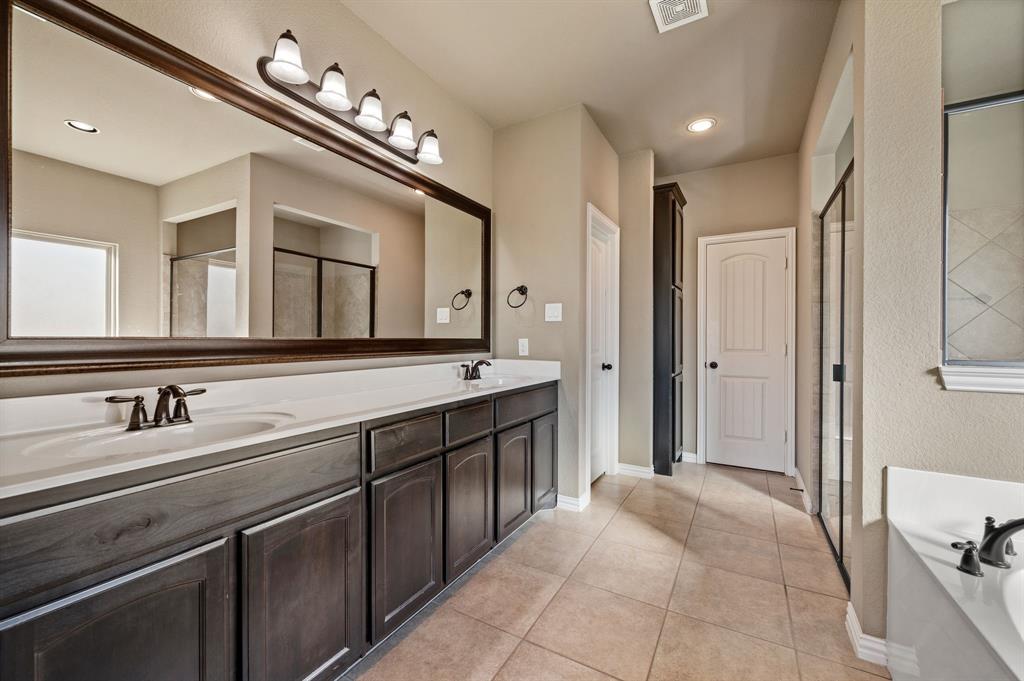 282 Heather Lane Decatur, TX 76234 - Photo 19 of 36 a spacious bathroom with a double vanity sink a mirror and a bathtub