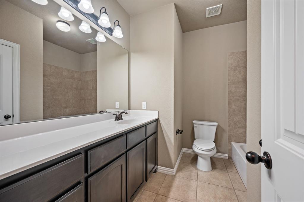 282 Heather Lane Decatur, TX 76234 - Photo 23 of 36 a bathroom with a sink a toilet and a mirror