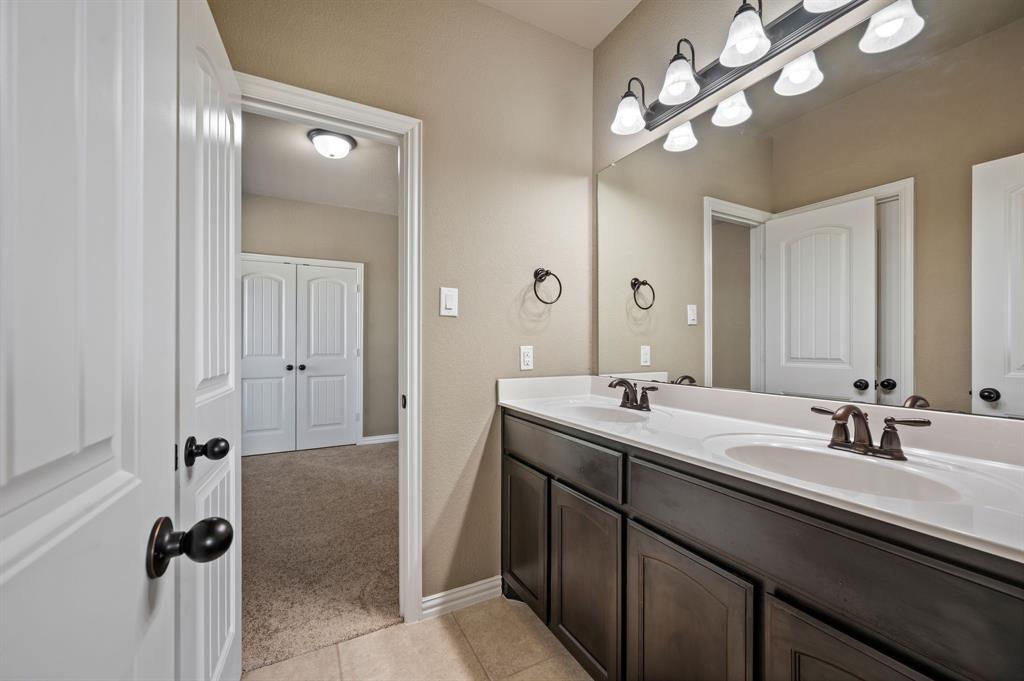 282 Heather Lane Decatur, TX 76234 - Photo 25 of 36 a bathroom with a double vanity sink and a mirror