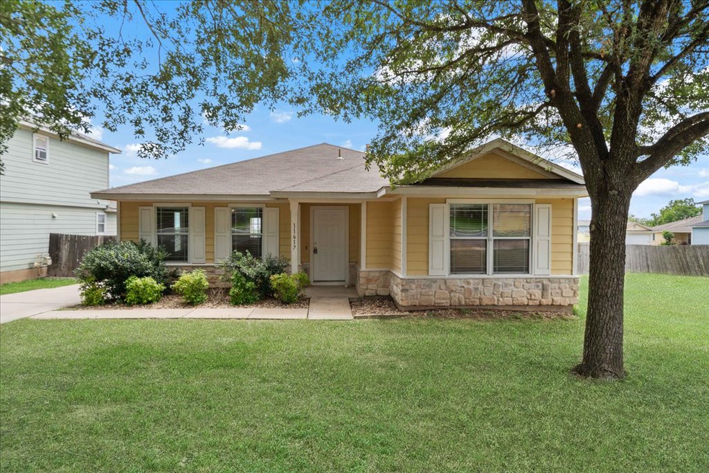 a front view of a house with a yard and porch