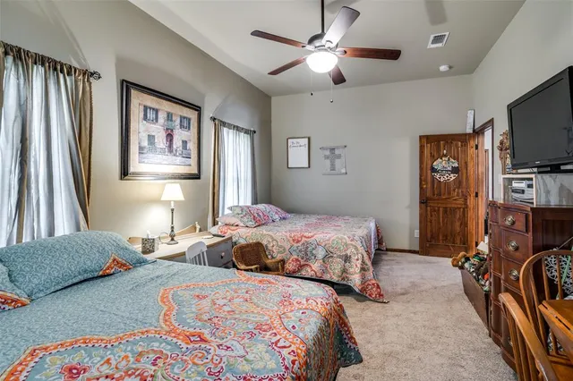 a bedroom with two beds and a flat screen tv