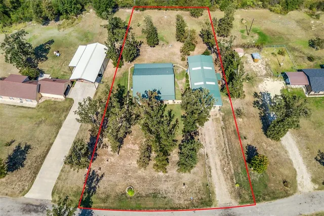 an aerial view of a residential houses with outdoor space