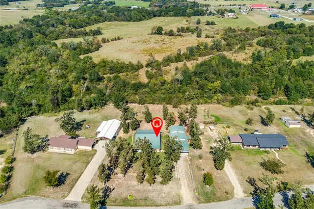 an aerial view of residential houses with outdoor space and swimming pool