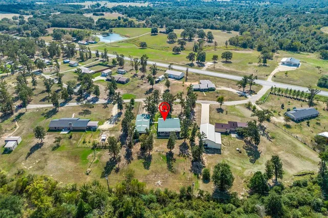 an aerial view of residential houses with outdoor space