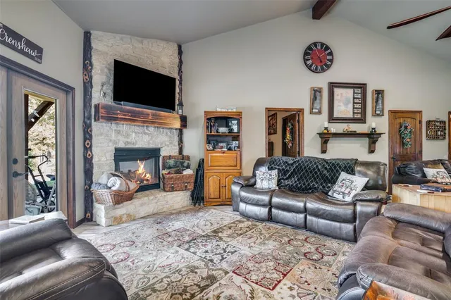 a living room with furniture flat screen tv and a fireplace
