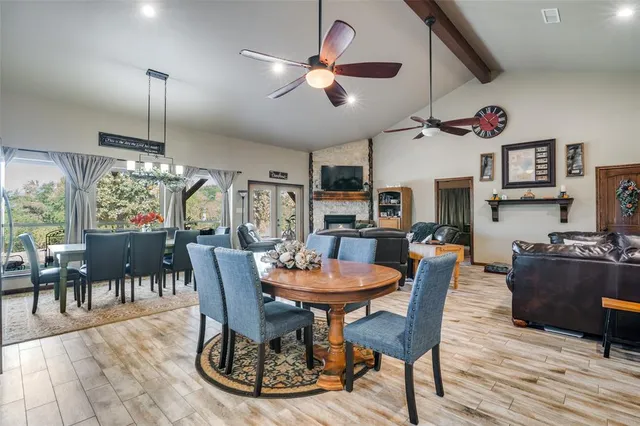 a dining room with furniture a chandelier and wooden floor