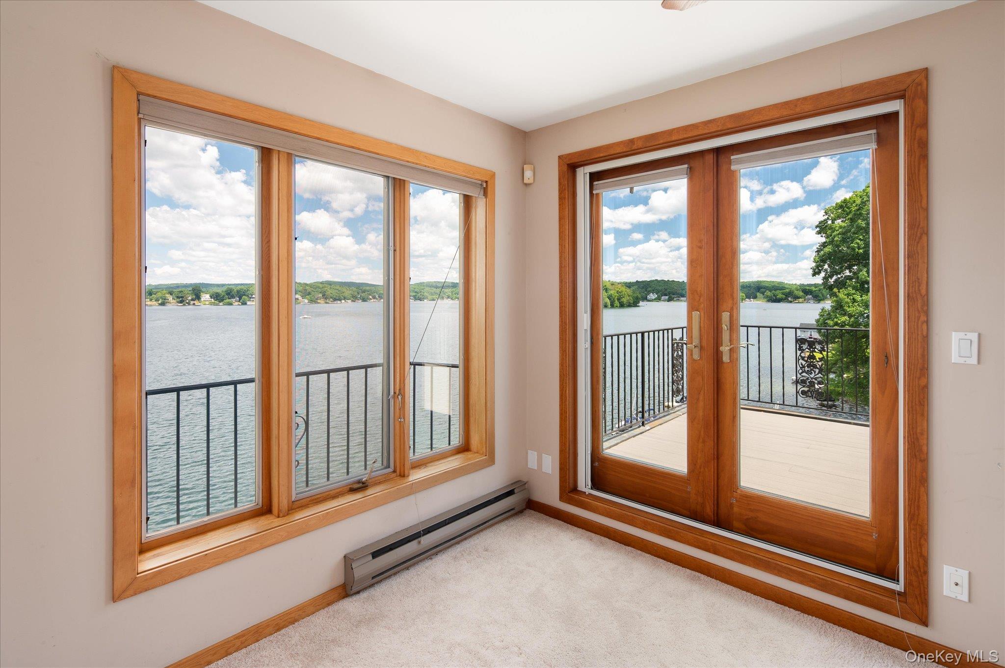 41 Tamarack Road Mahopac, NY 10541 - Photo 33 of 41 French doors open onto a private deck with sweeping Lake Mahopac views from this upper level bedroom