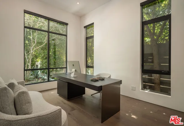 a living room with furniture and a floor to ceiling window