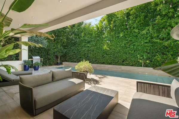 a terrace with outdoor seating and trees