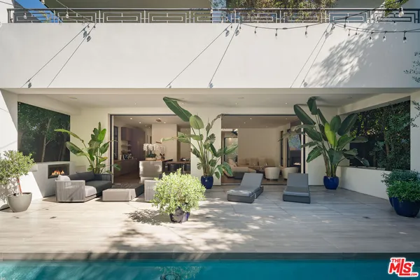 a view of a house with yard and sitting area