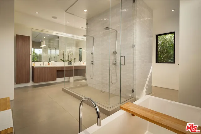 a bathroom with a tub and a shower
