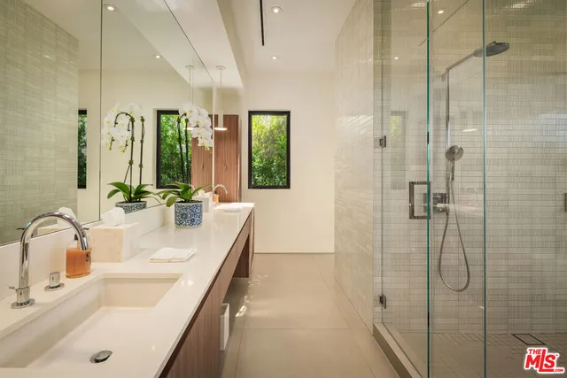 a bathroom with a tub sink and mirror