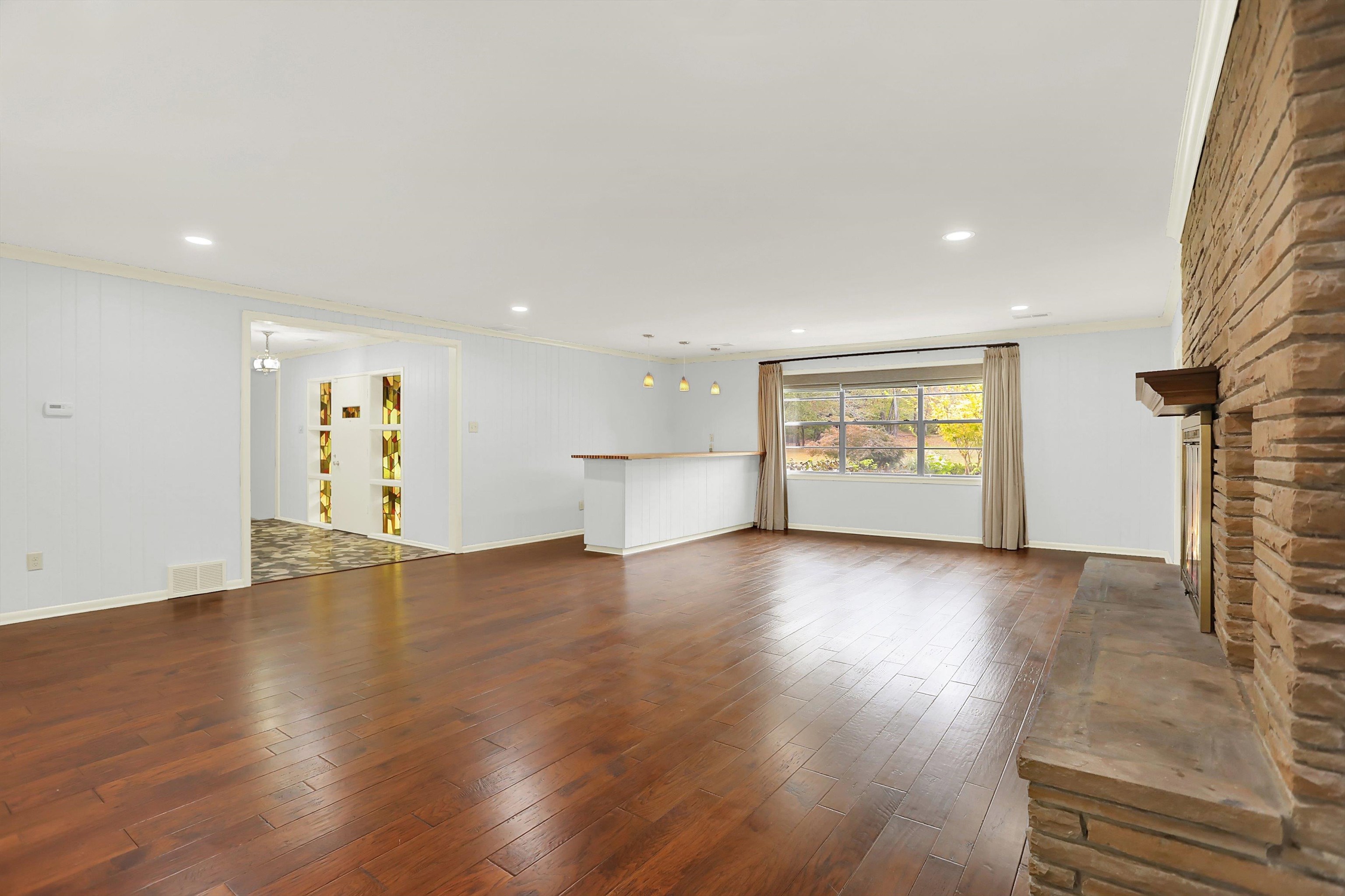 280 Waring Road Memphis, TN 38117 - Photo 5 of 38 a view of an empty room with a window and wooden floor