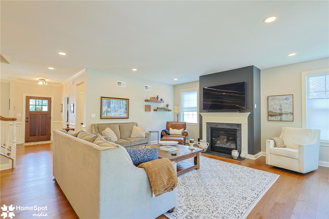 4518 Old Saucon Road Bethlehem, PA 18015 - Photo 5 of 19 A refined living space features rich hardwood flooring and a cozy fireplace with a classic mantel.