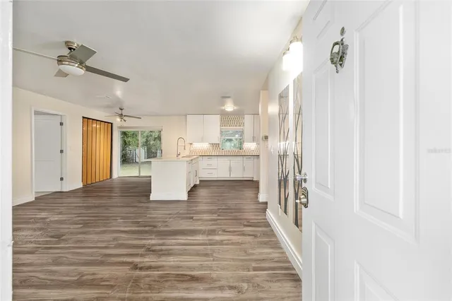 wooden floor fireplace and windows in an empty room