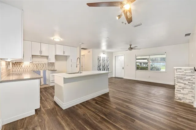 a kitchen with white cabinets and white appliances
