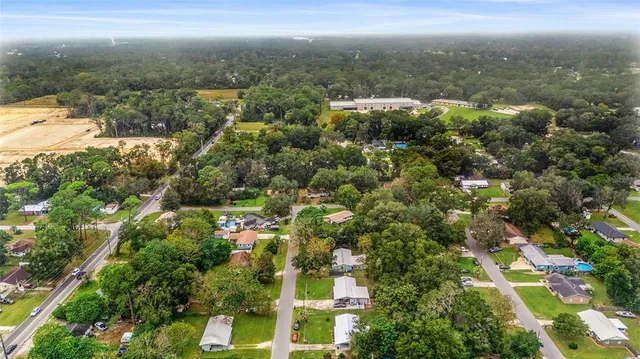 a view of a kitchen with wooden floor and a kitchen space