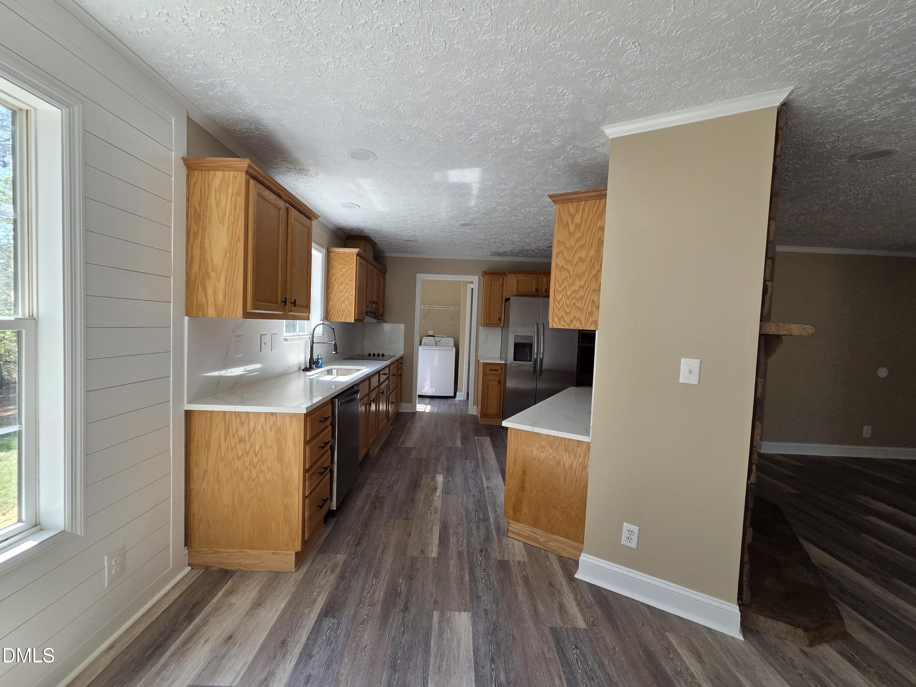 664 Glebe Road Henderson, NC 27537 - Photo 11 of 44 a kitchen with stainless steel appliances granite countertop a sink stove and refrigerator