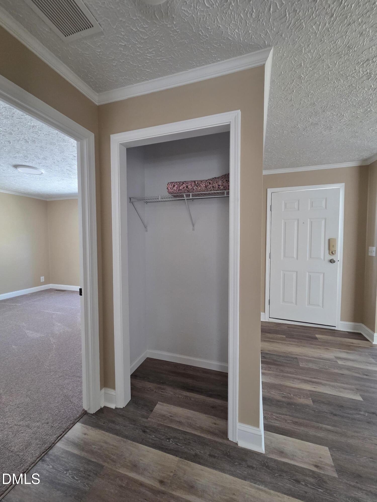 664 Glebe Road Henderson, NC 27537 - Photo 20 of 44 an empty room with wooden floor & closet area
