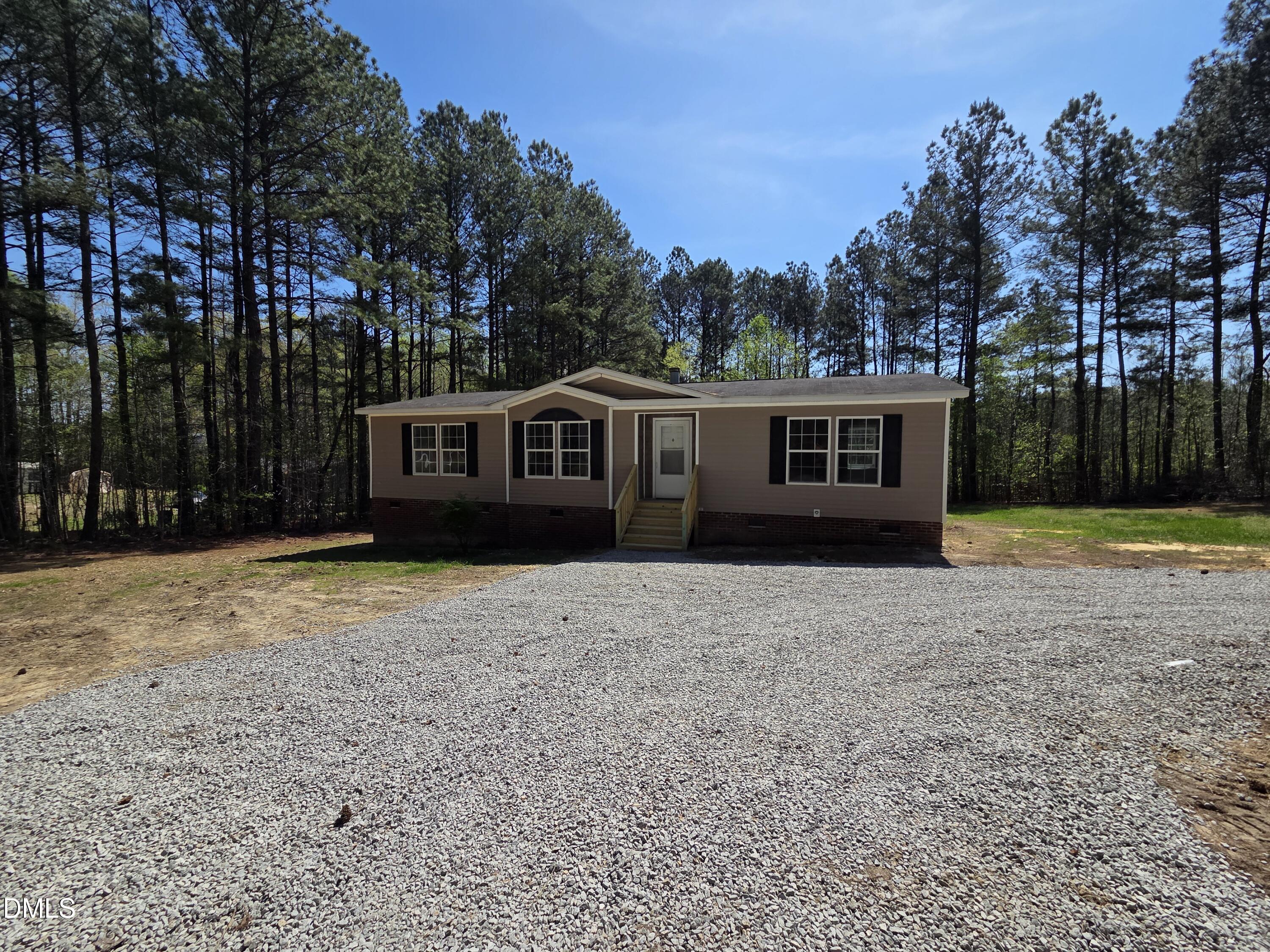 664 Glebe Road Henderson, NC 27537 - Photo 2 of 44 a view of a house with backyard and trees