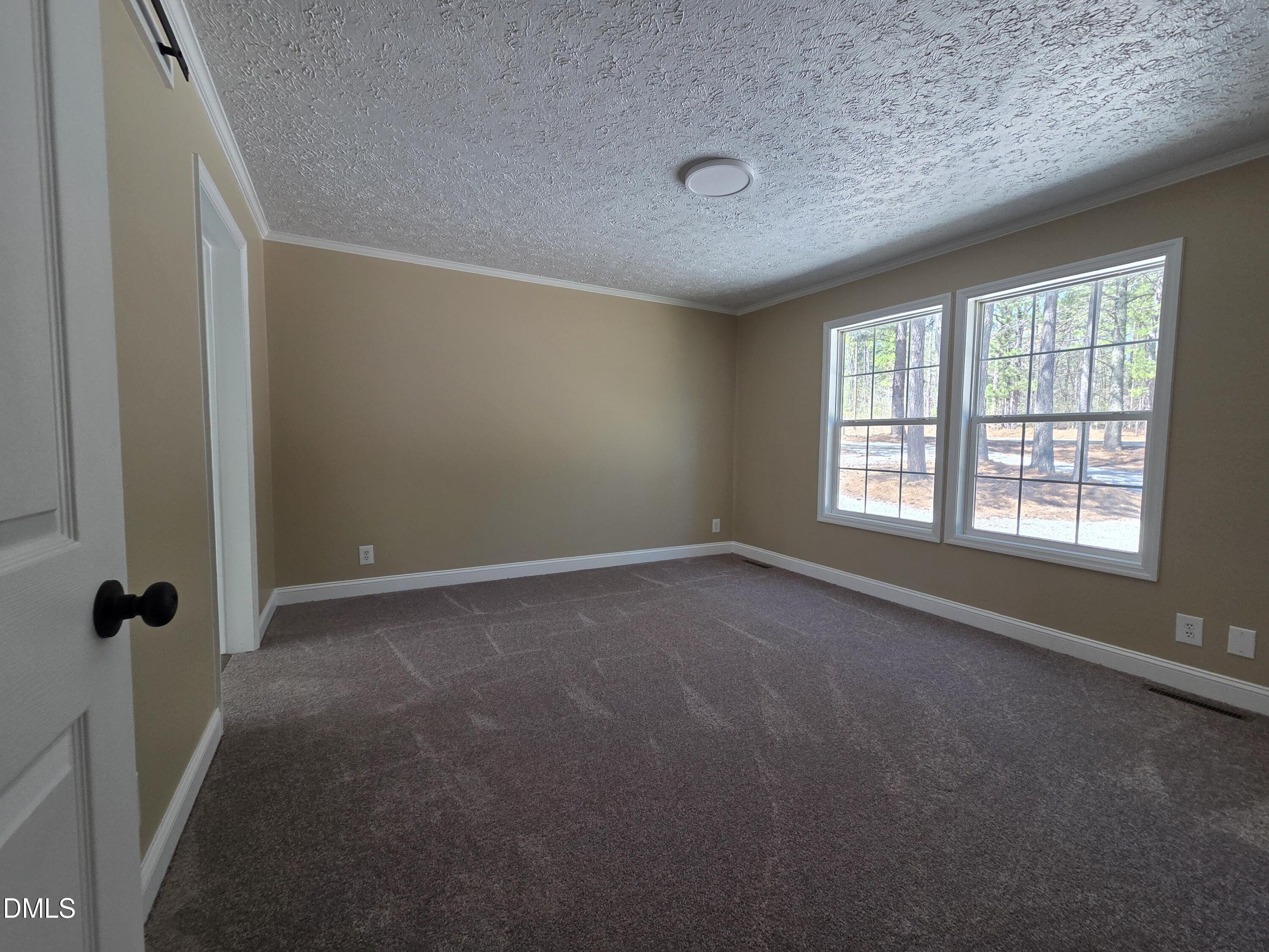 664 Glebe Road Henderson, NC 27537 - Photo 21 of 44 an empty room with windows