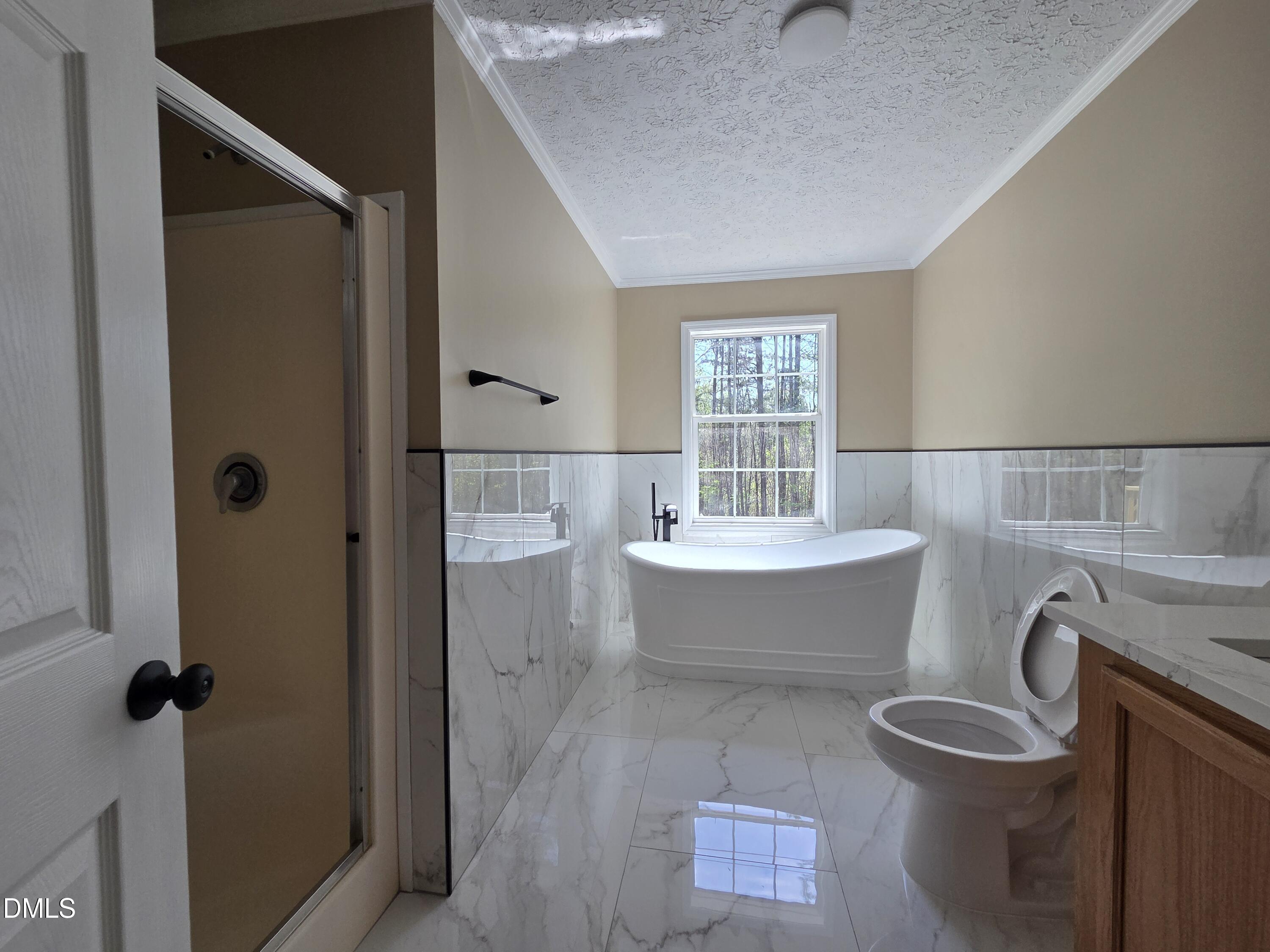 664 Glebe Road Henderson, NC 27537 - Photo 29 of 44 a bathroom with a bathtub shower sink mirror and toilet