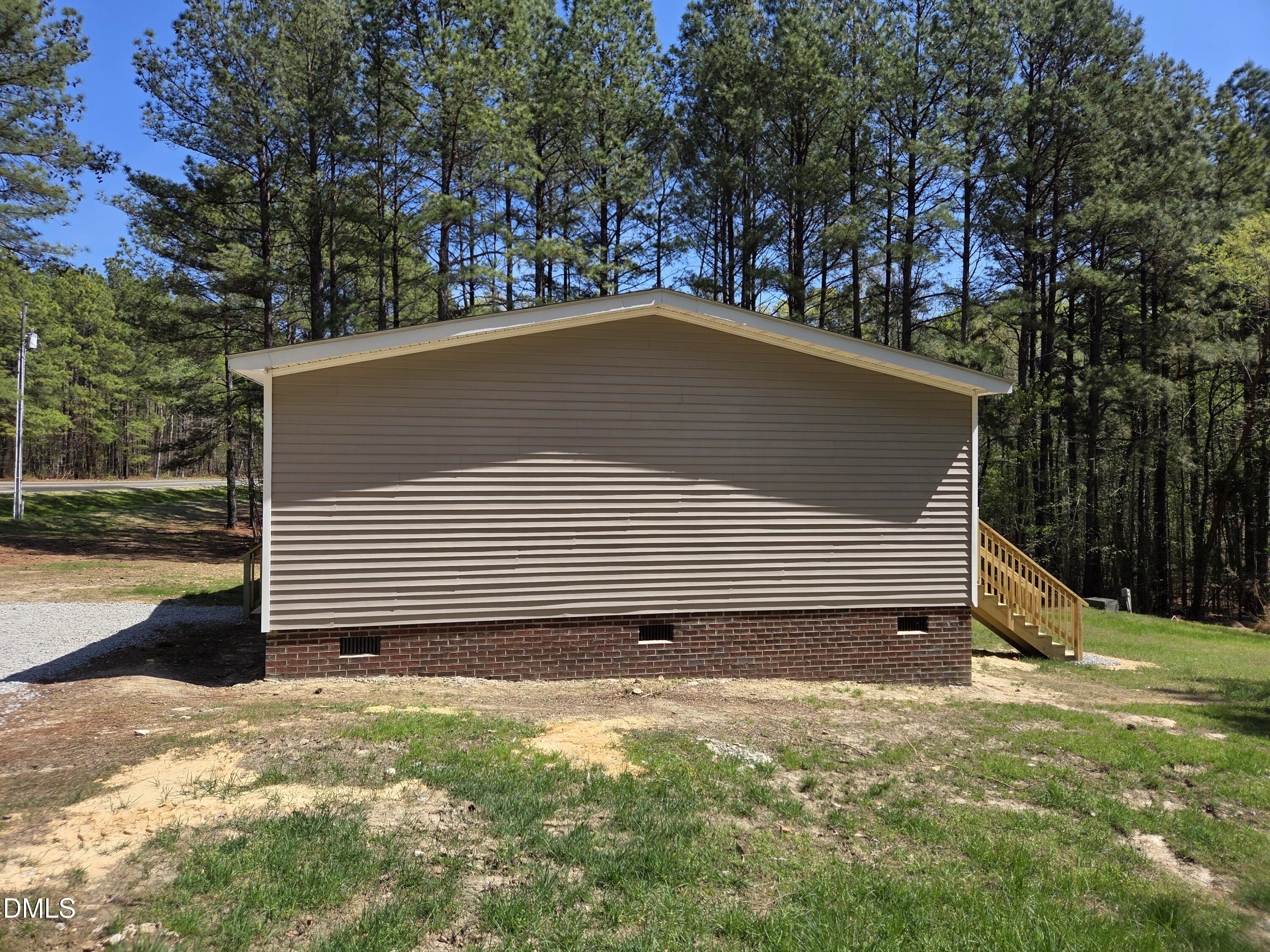 664 Glebe Road Henderson, NC 27537 - Photo 3 of 44 a view of a house with backyard and garden