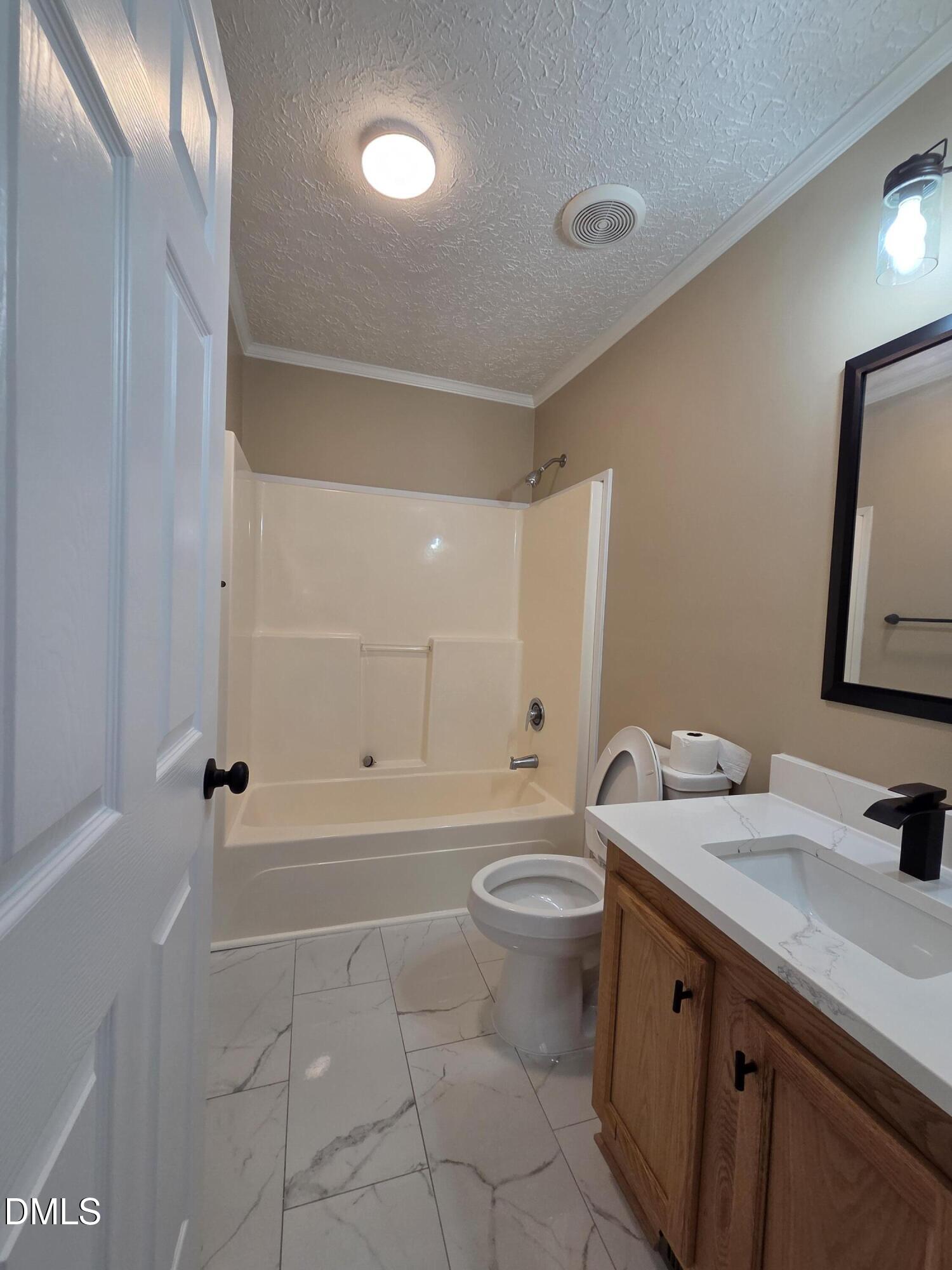 664 Glebe Road Henderson, NC 27537 - Photo 42 of 44 a bathroom with a sink a toilet and shower