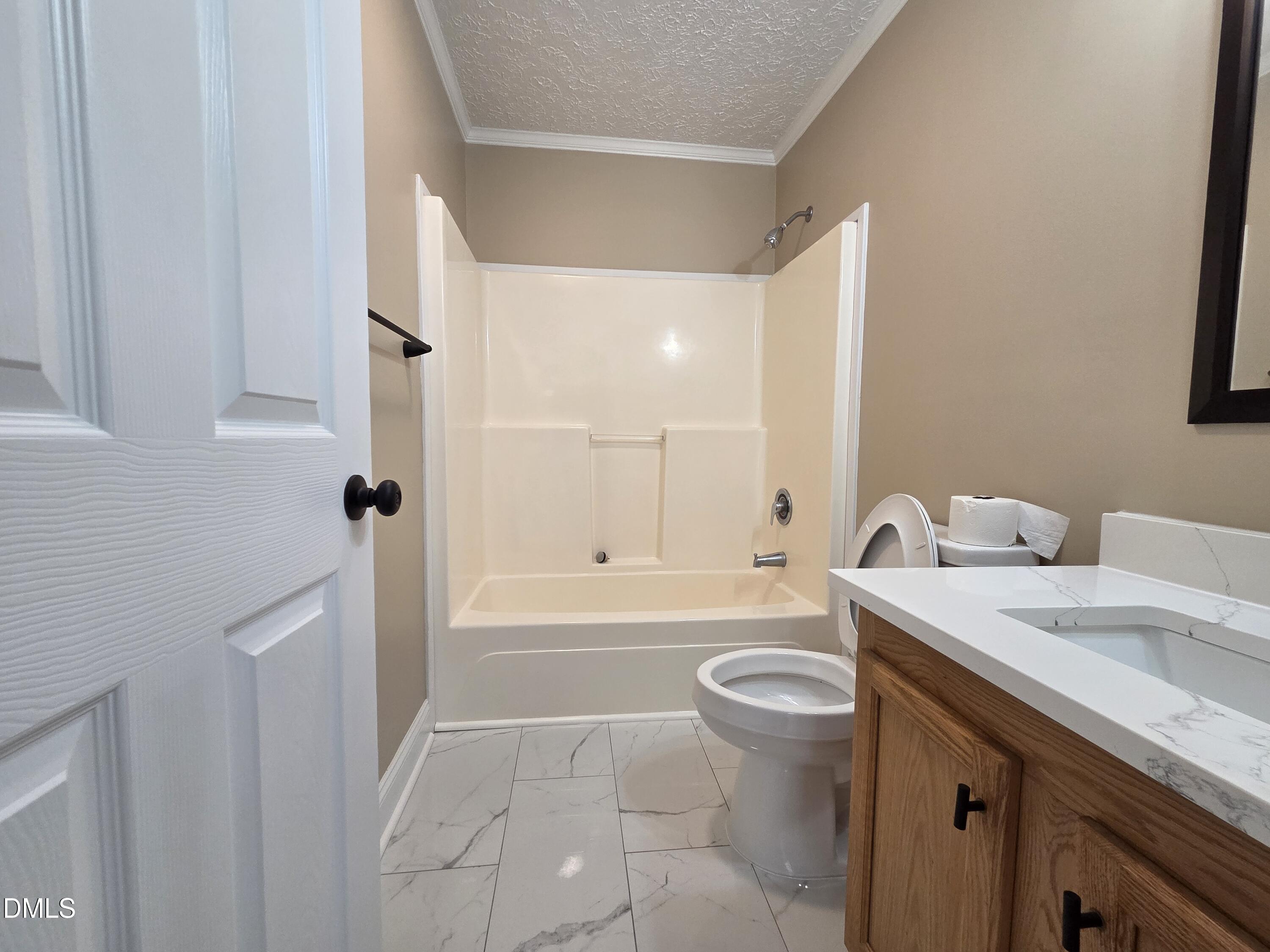 664 Glebe Road Henderson, NC 27537 - Photo 44 of 44 a bathroom with a sink a toilet and shower