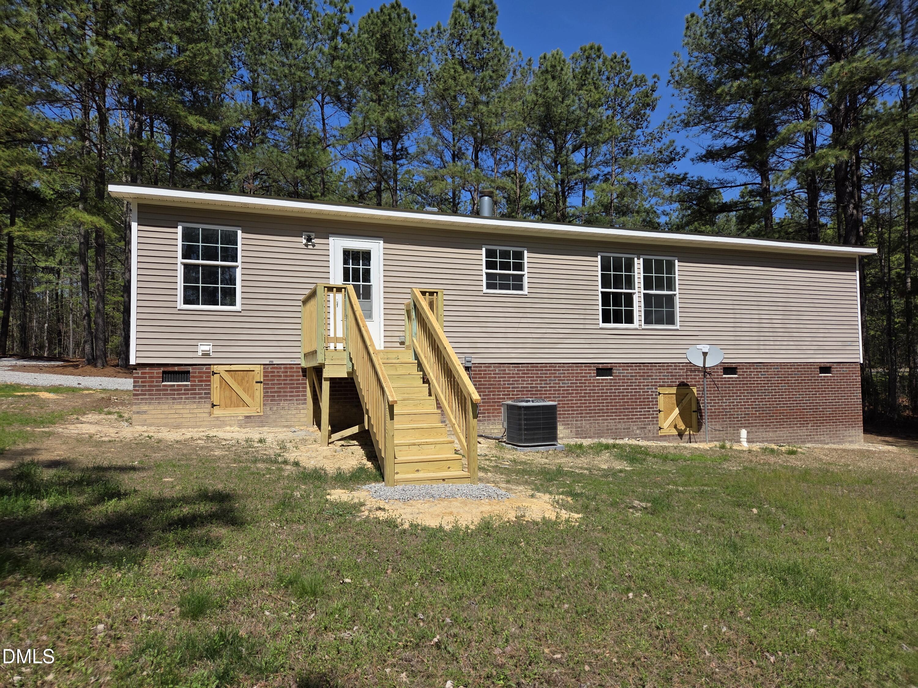 664 Glebe Road Henderson, NC 27537 - Photo 5 of 44 a view of a backyard with a sitting area