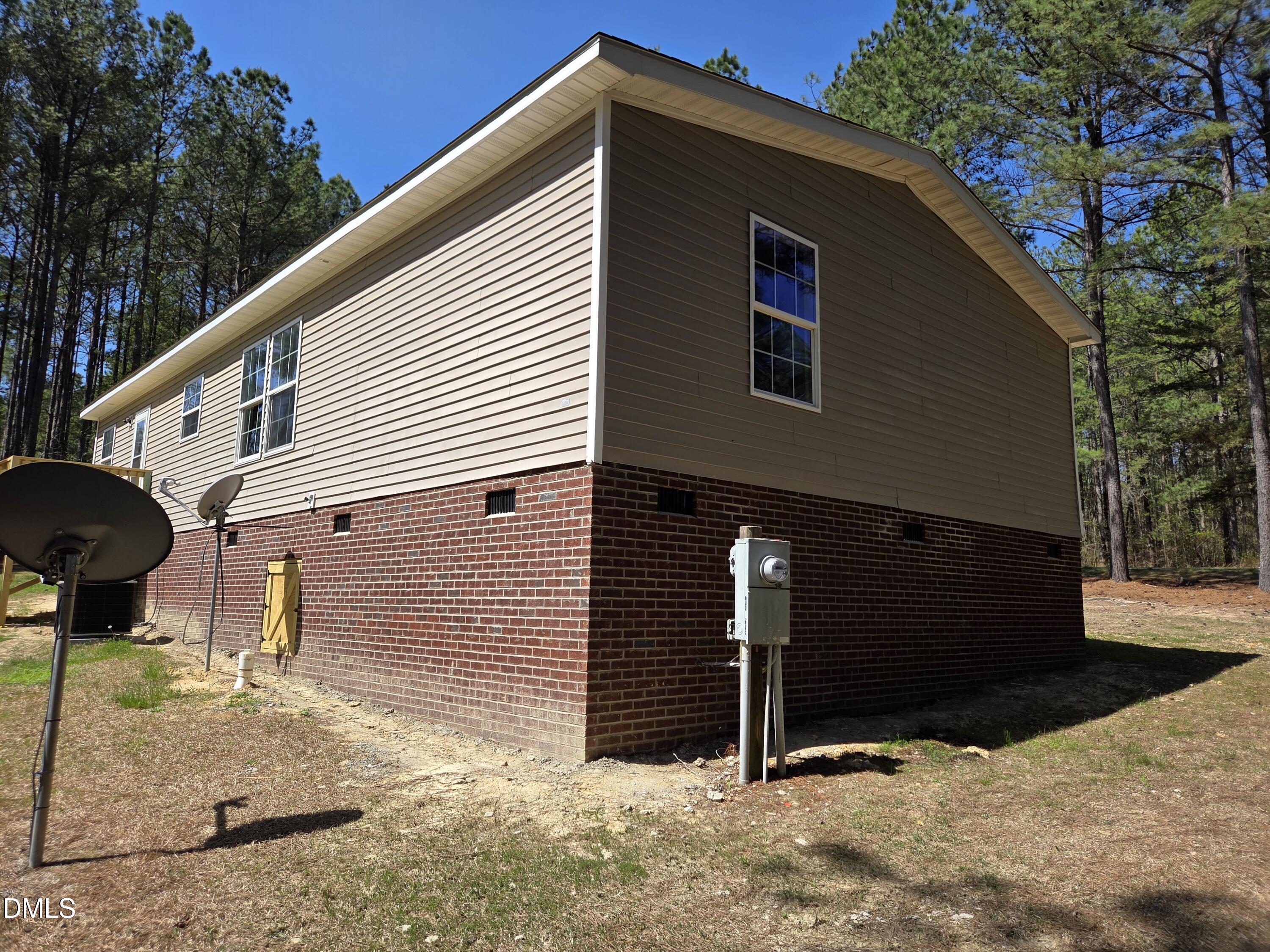 664 Glebe Road Henderson, NC 27537 - Photo 6 of 44 a front view of a house with garage