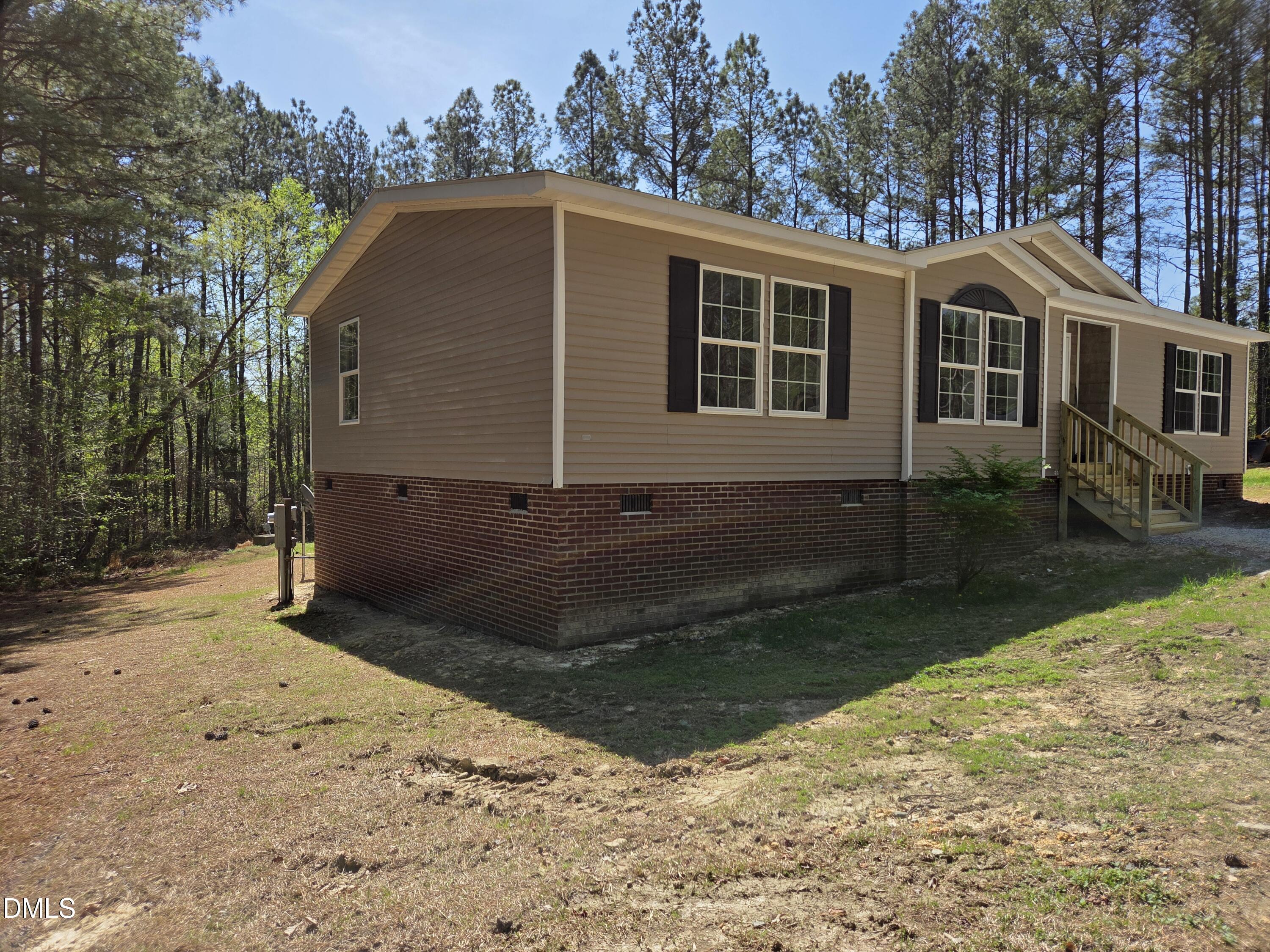 664 Glebe Road Henderson, NC 27537 - Photo 7 of 44 a front view of a house with a yard