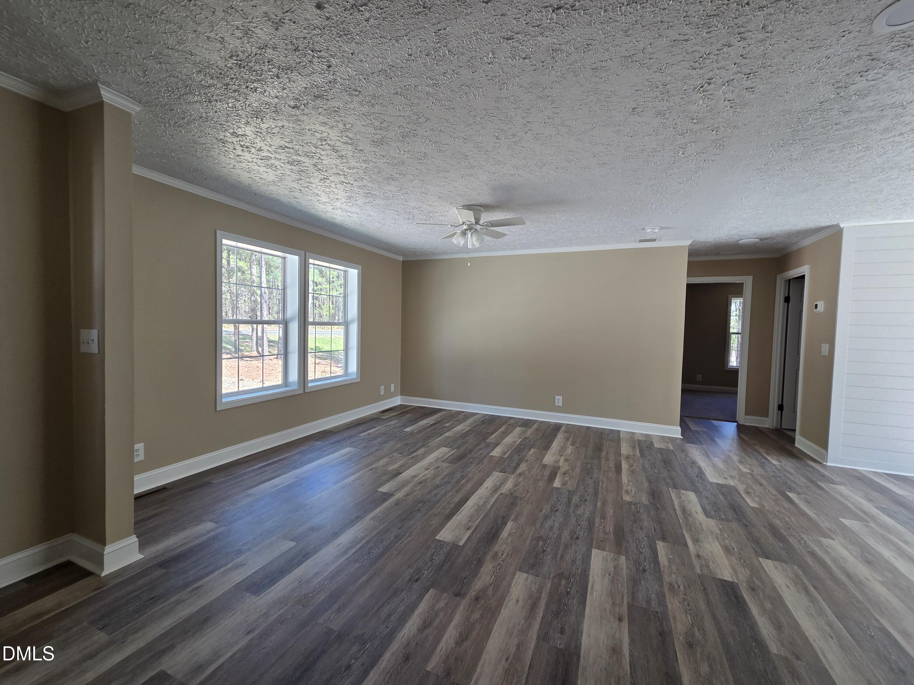 664 Glebe Road Henderson, NC 27537 - Photo 9 of 44 an empty room with wooden floor and windows
