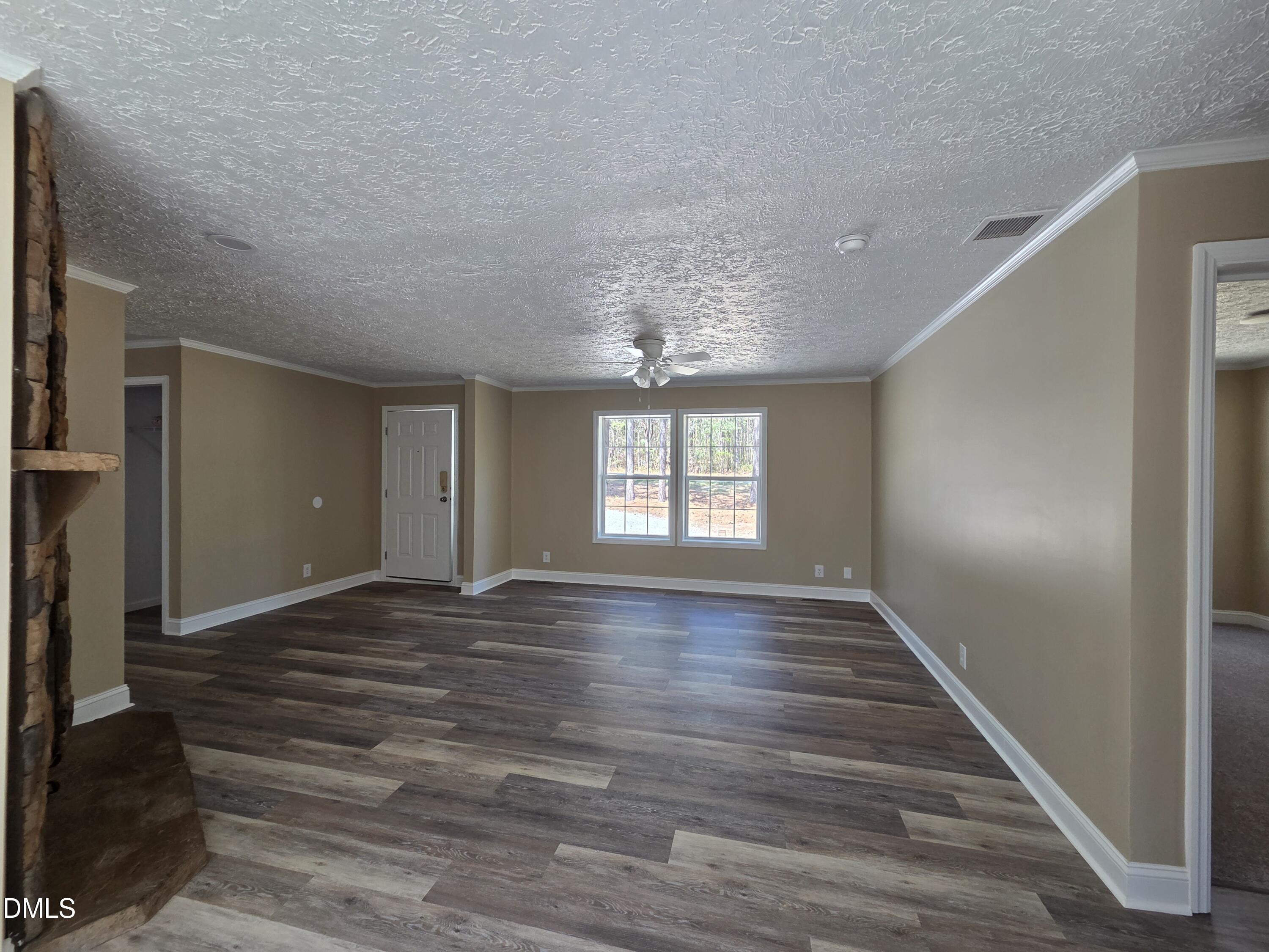 664 Glebe Road Henderson, NC 27537 - Photo 10 of 44 a view of an empty room with wooden floor and a window