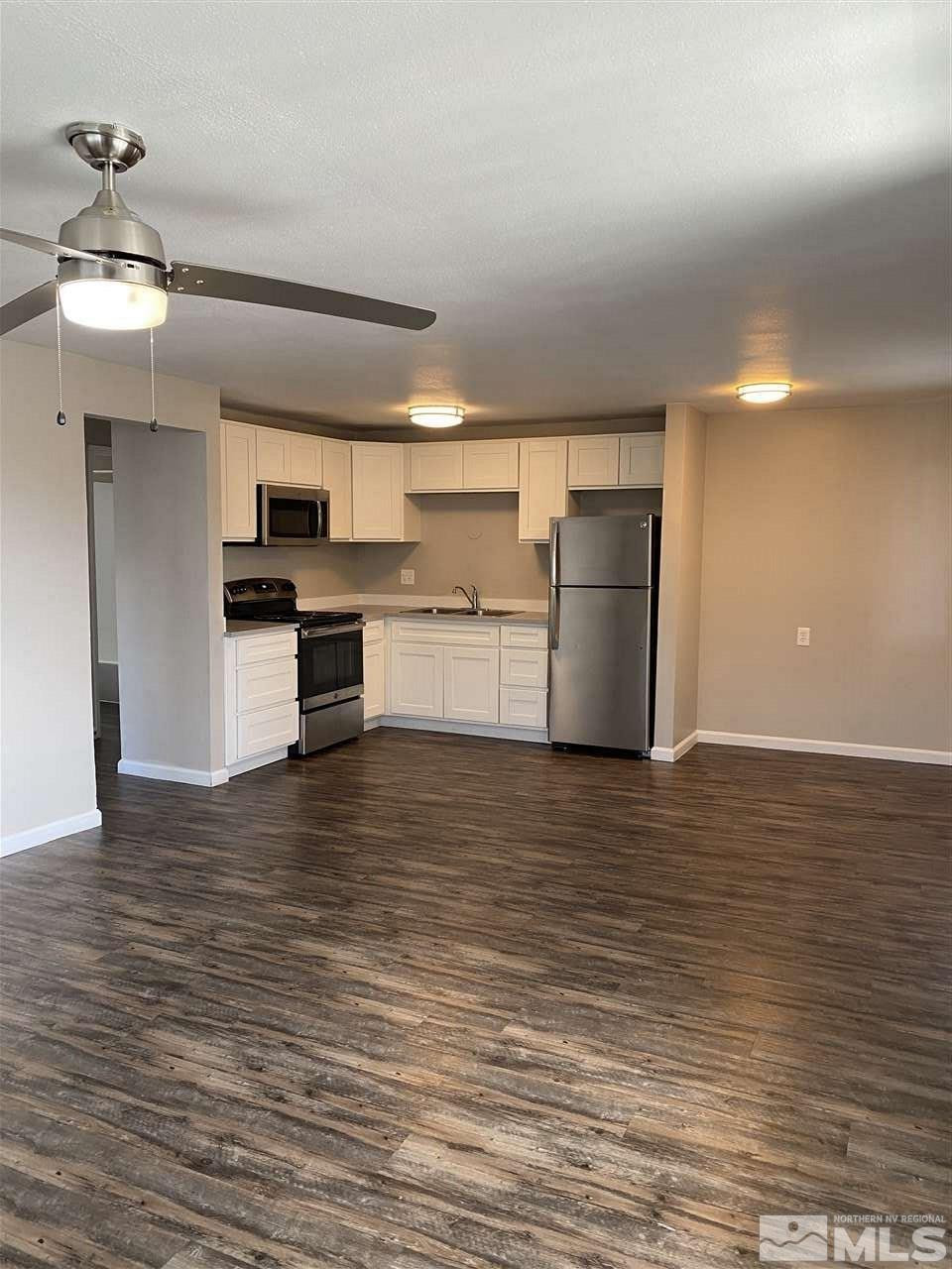 1365 Stardust Street, Unit 3 Reno, NV 89503 - Photo 9 of 9 a kitchen with a refrigerator and a stove top oven