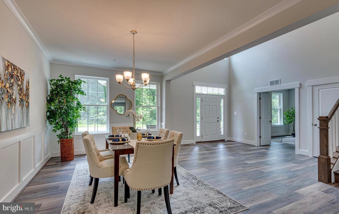 6709 Deep Run Trail Hanover, MD 21076 - Photo 4 of 12 a view of a dining room with furniture window and wooden floor