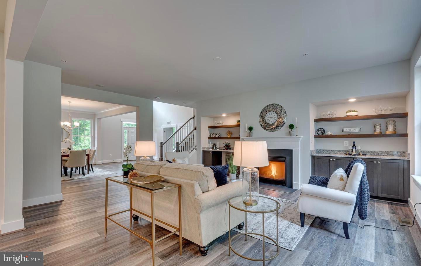 6709 Deep Run Trail Hanover, MD 21076 - Photo 7 of 12 a living room with furniture kitchen view and a fireplace