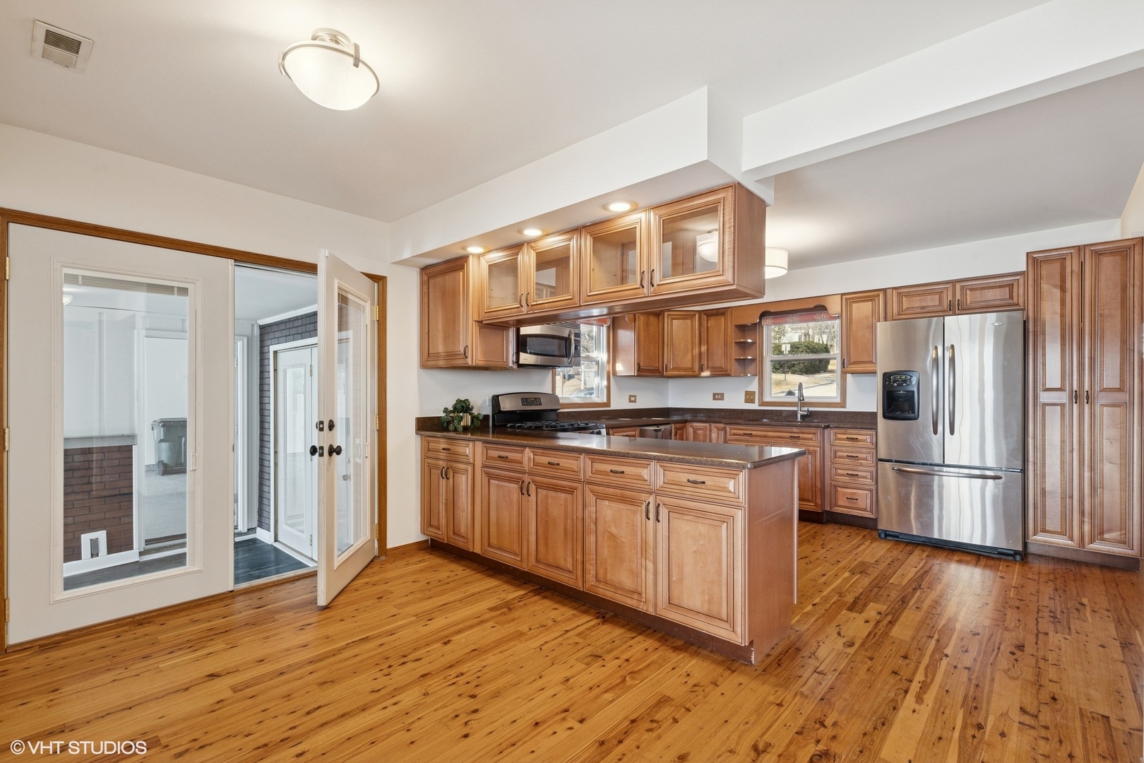 701 North Harrison Street Algonquin, IL 60102 - Photo 5 of 28 a kitchen with stainless steel appliances granite countertop a refrigerator a stove and a wooden floors